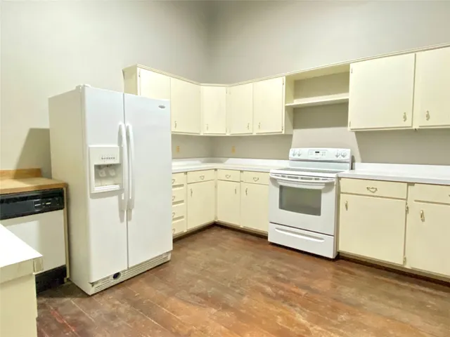 a kitchen with cabinets appliances and a window