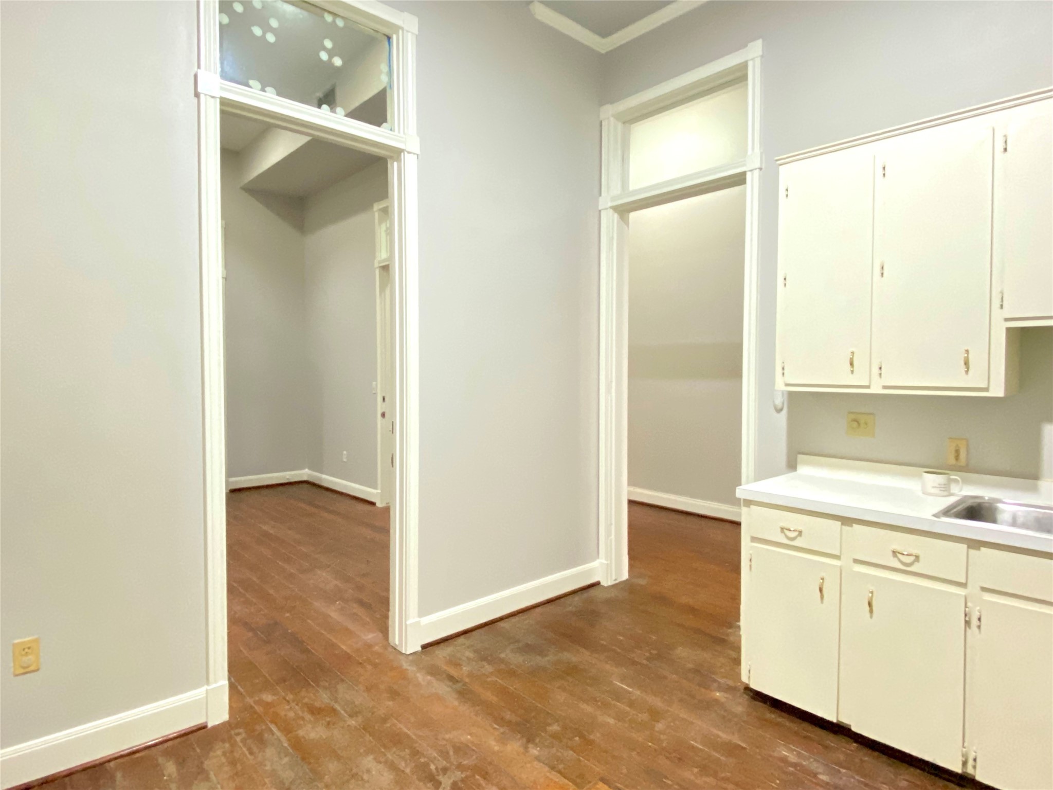 2319 The Strand, Unit 2A Galveston, TX 77550 - Photo 23 of 32 a view of cabinets a sink and a window in a room