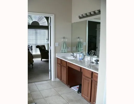 a en suite bathroom with a sink and a mirror