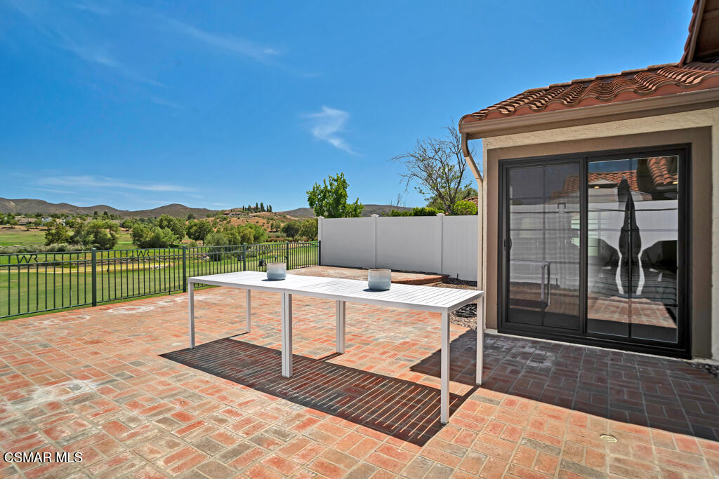 a view of a terrace with a table and chairs