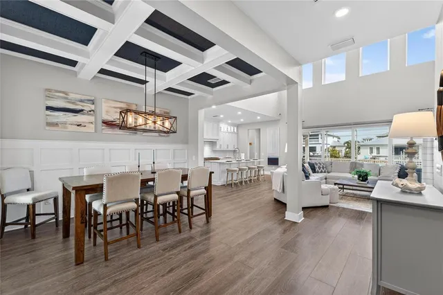 a living room with furniture wooden floor and a view of kitchen