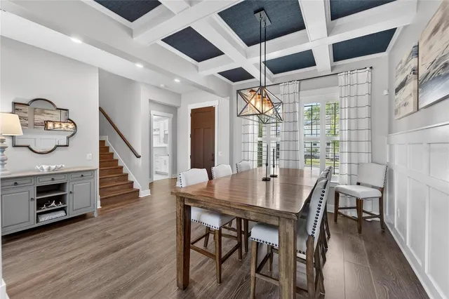a kitchen with a stove and a flat screen tv