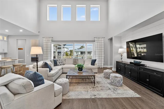 a kitchen with kitchen island granite countertop a sink and white cabinets