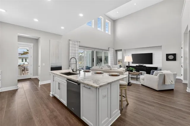 a bedroom with a large bed and a wooden floor