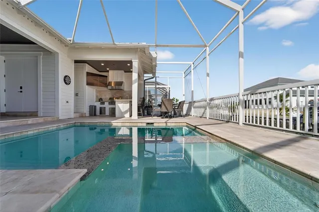 a kitchen with stainless steel appliances granite countertop a sink a stove and a refrigerator