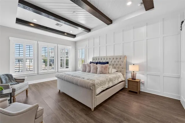 a bathroom with a toilet sink vanity and mirror