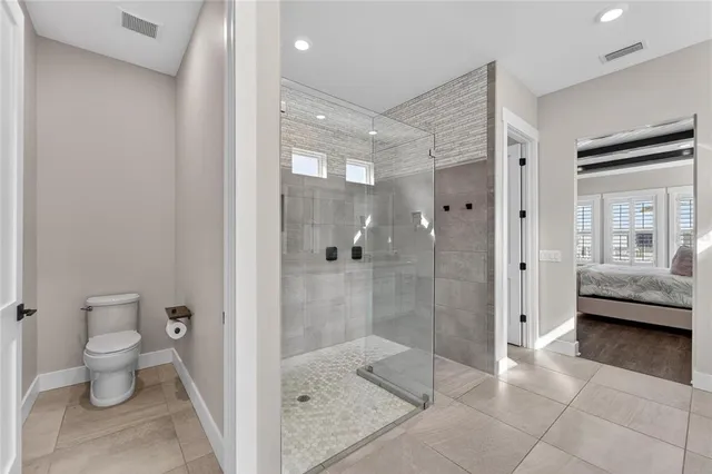 a view of a room with wooden floor and ceiling fan