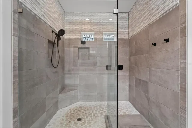 a view of a livingroom with wooden floor and a ceiling fan