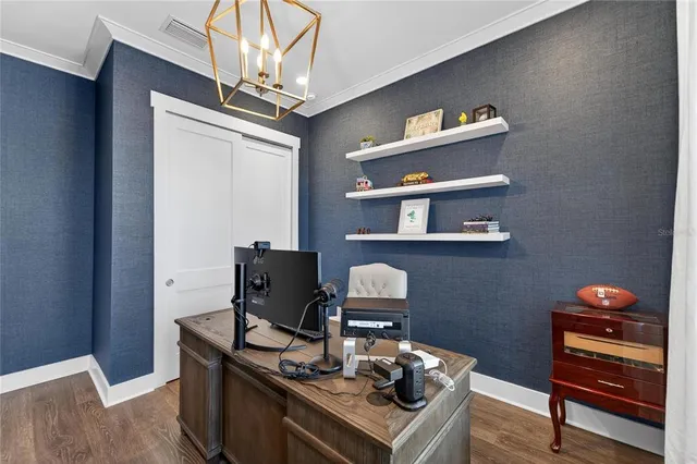 a bedroom with a bed a chandelier and a window