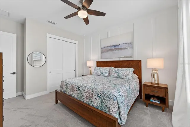 a bedroom with a large bed and a chandelier