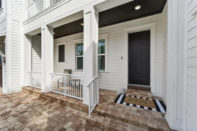 a living room with furniture a flat screen tv and wooden floor