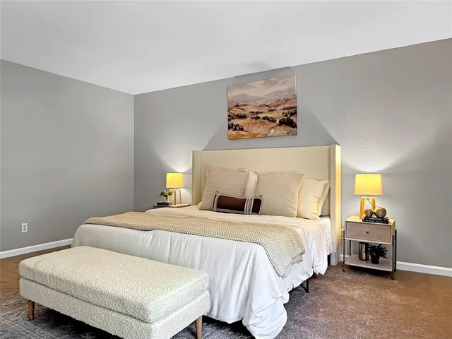 a bedroom with a bed and a couch