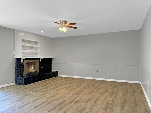 a view of empty room with a fireplace