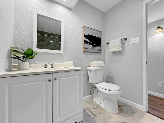 a bathroom with a sink toilet and mirror