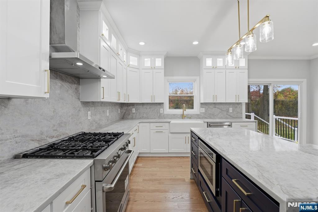 20 Barnsdale Road Wayne, NJ 07470 - Photo 13 of 40 a kitchen with a sink stove top oven and cabinets