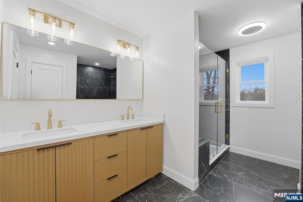 20 Barnsdale Road Wayne, NJ 07470 - Photo 22 of 40 a bathroom with a double vanity sink and mirror