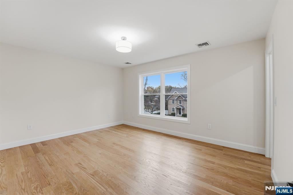 20 Barnsdale Road Wayne, NJ 07470 - Photo 27 of 40 an empty room with wooden floor and windows