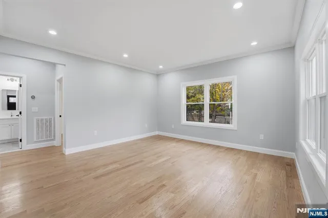 a large kitchen with granite countertop a large counter top appliances and cabinets