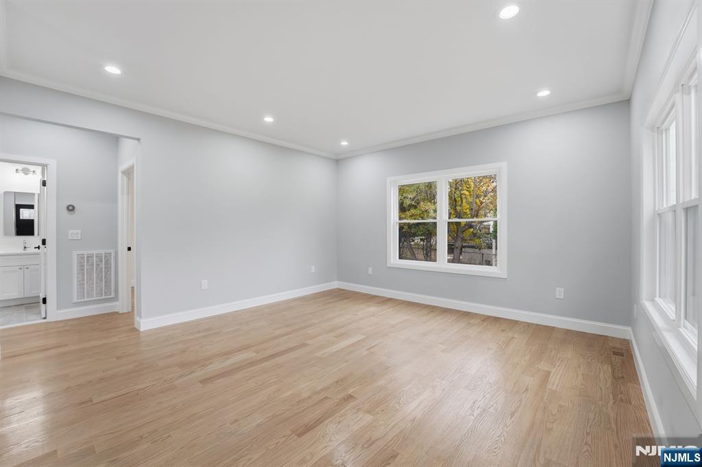 20 Barnsdale Road Wayne, NJ 07470 - Photo 6 of 40 a view of an empty room with wooden floor and a window