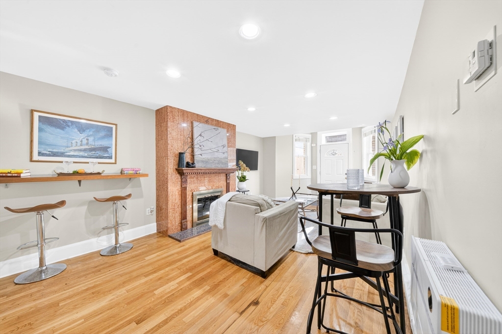 352 Tappan Street, Unit 1 Brookline, MA 02445 - Photo 10 of 42 a living room with furniture and a wooden floor