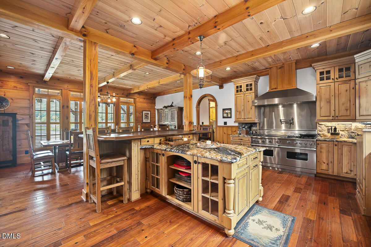 390 Line Creek Farm Road Yanceyville, NC 27379 - Photo 23 of 102 a view of a kitchen with stainless steel appliances granite countertop a stove and a wooden floors