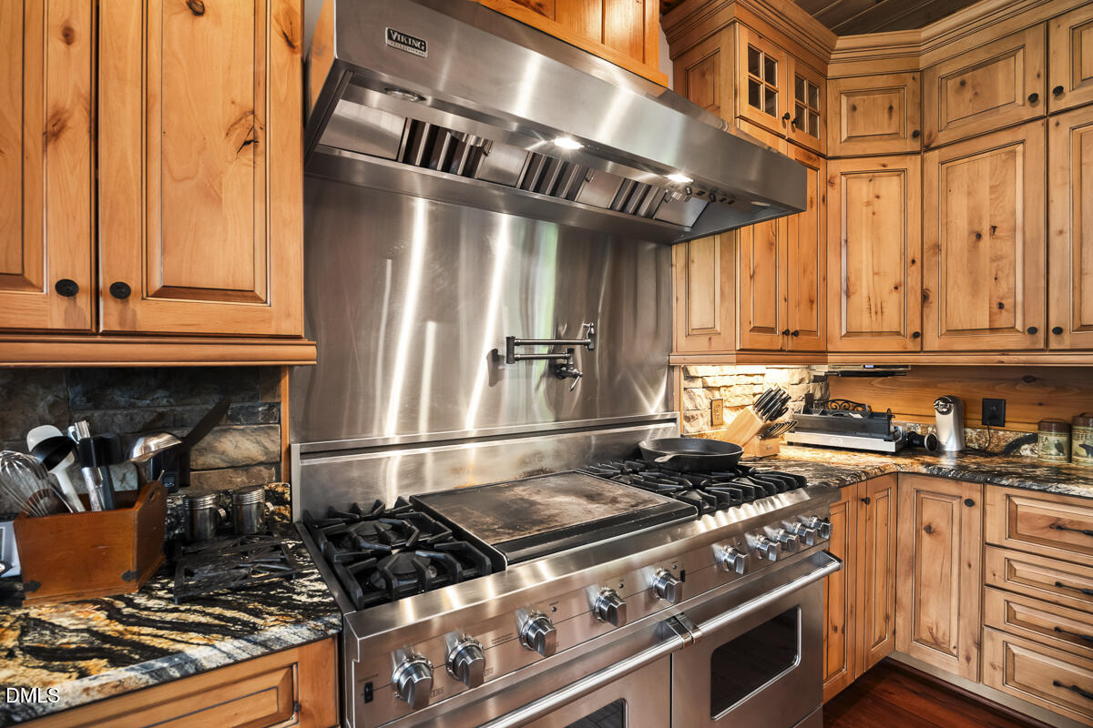 390 Line Creek Farm Road Yanceyville, NC 27379 - Photo 24 of 102 a kitchen with a stove and a refrigerator
