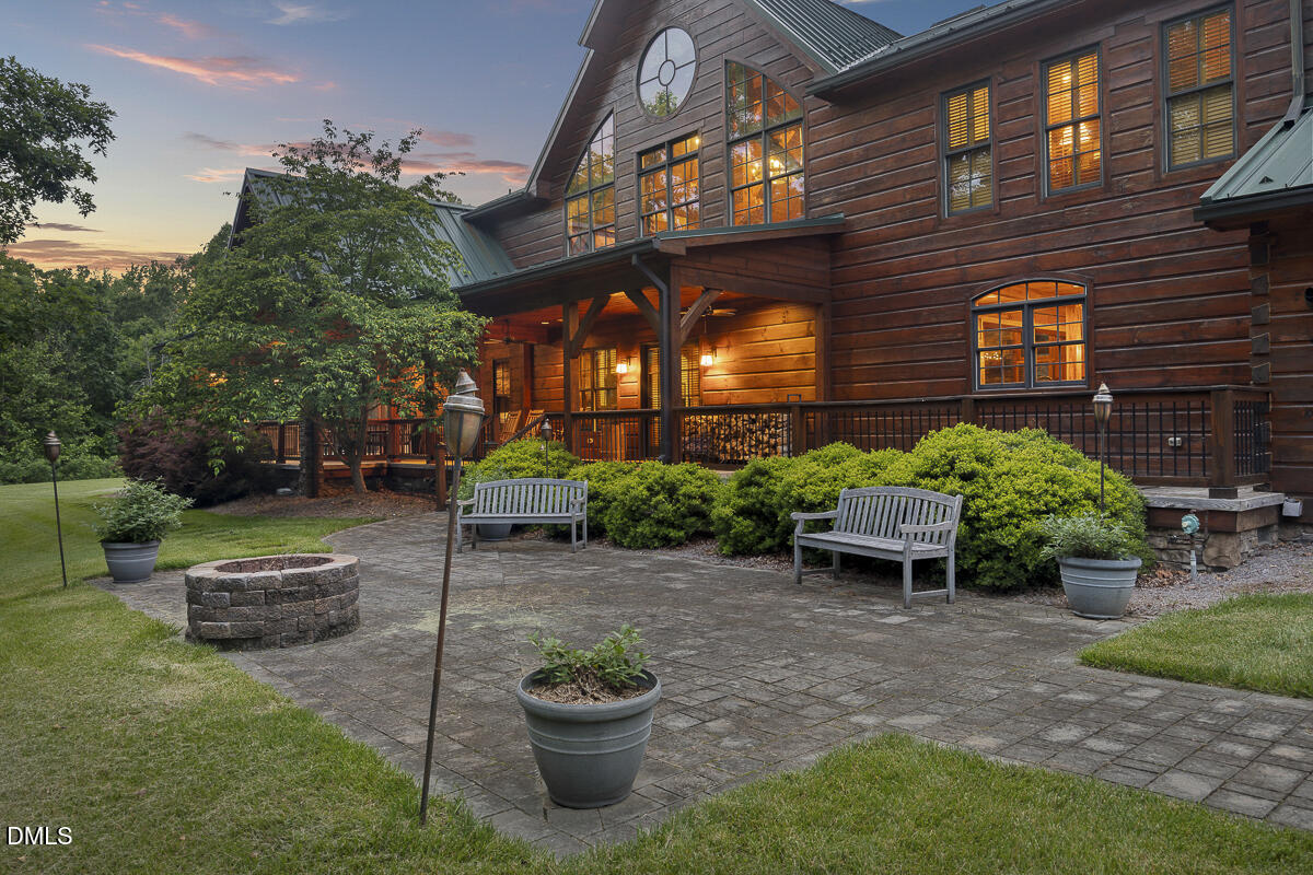 390 Line Creek Farm Road Yanceyville, NC 27379 - Photo 8 of 102 a view of a patio with table and chairs and potted plants
