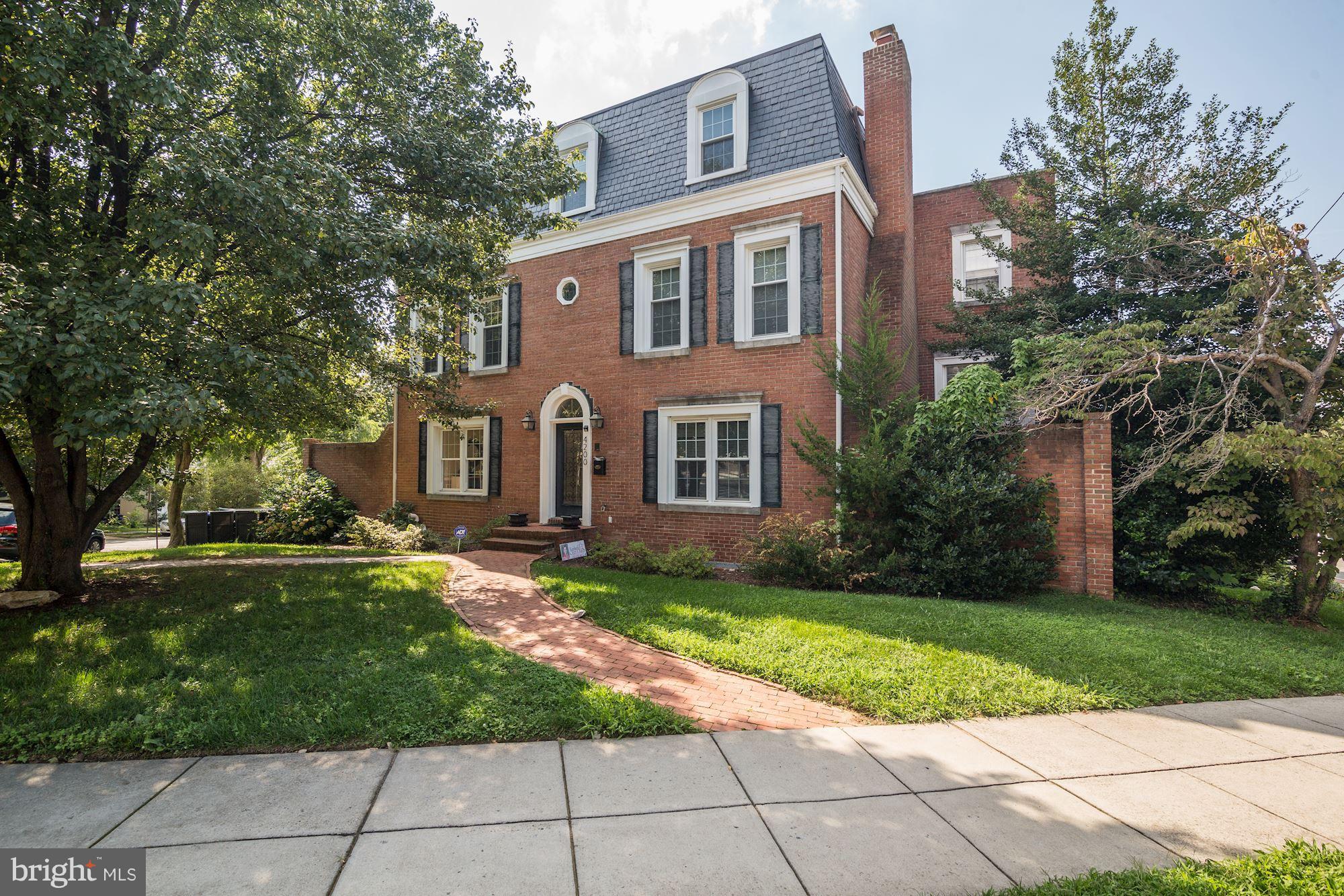 a view of a brick house with a yard