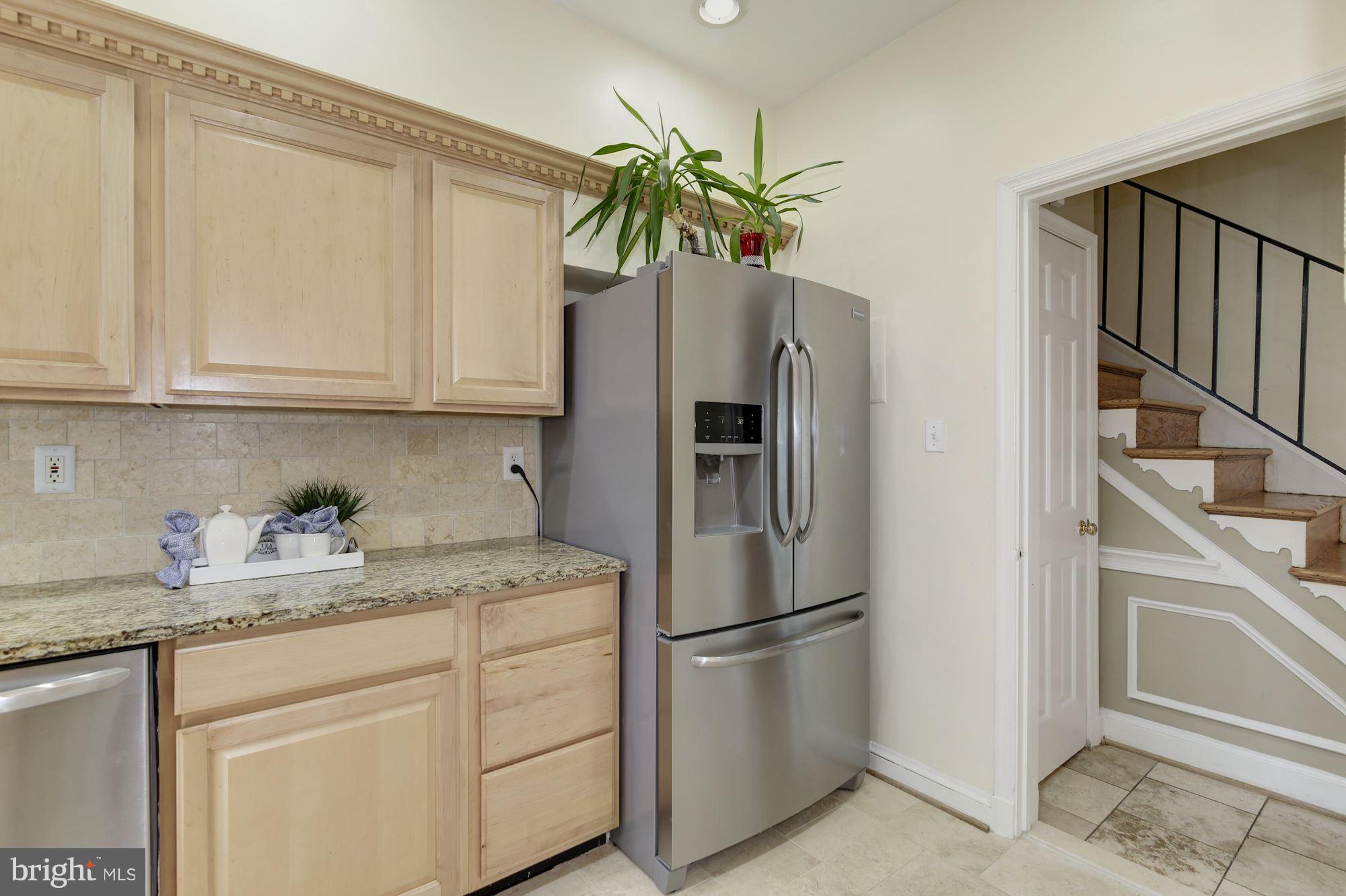 4200 River Road Northwest Washington, DC 20016 - Photo 10 of 30 a kitchen with stainless steel appliances granite countertop a refrigerator sink and cabinets