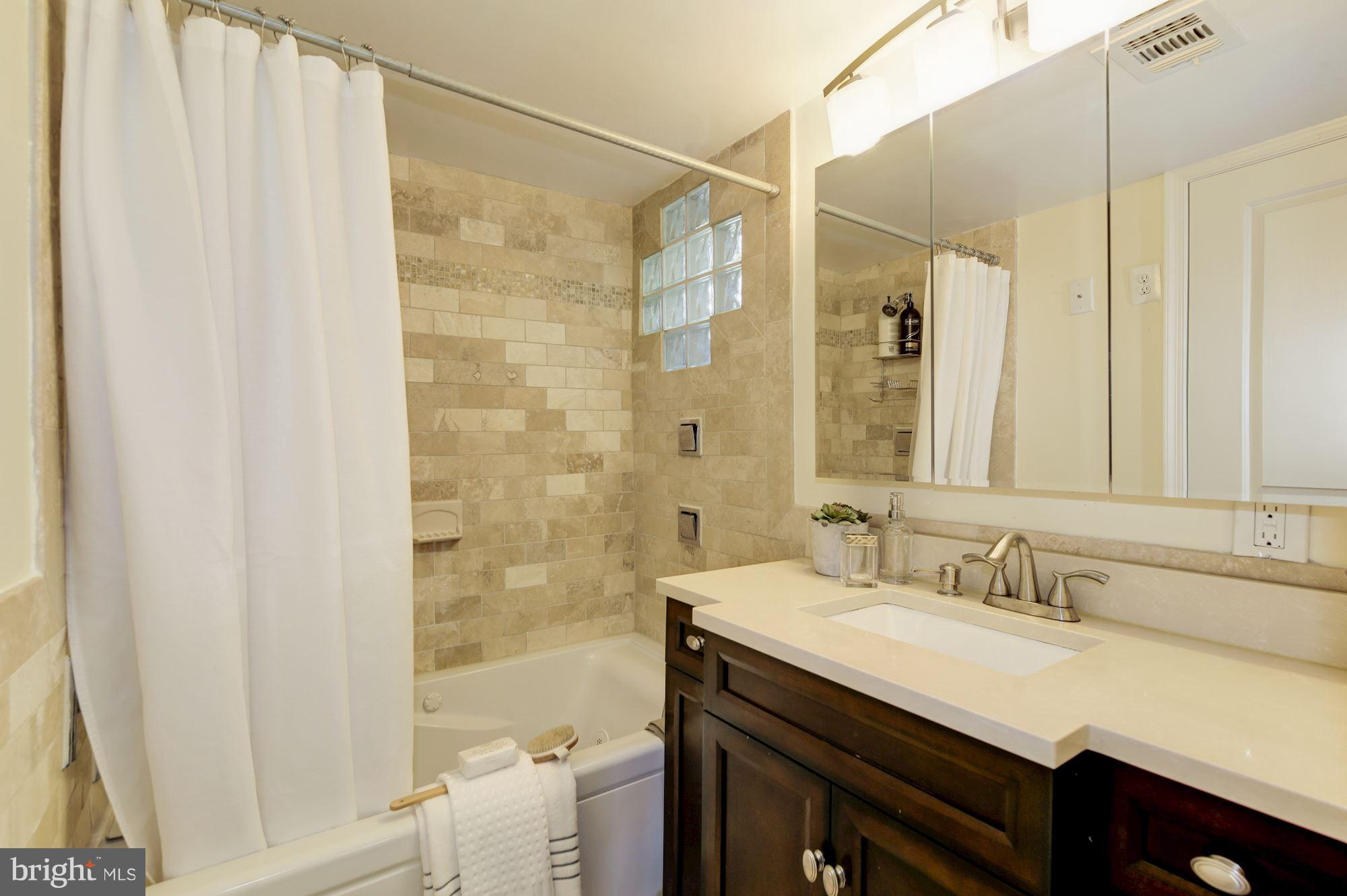 4200 River Road Northwest Washington, DC 20016 - Photo 12 of 30 a bathroom with a granite countertop sink a toilet and shower