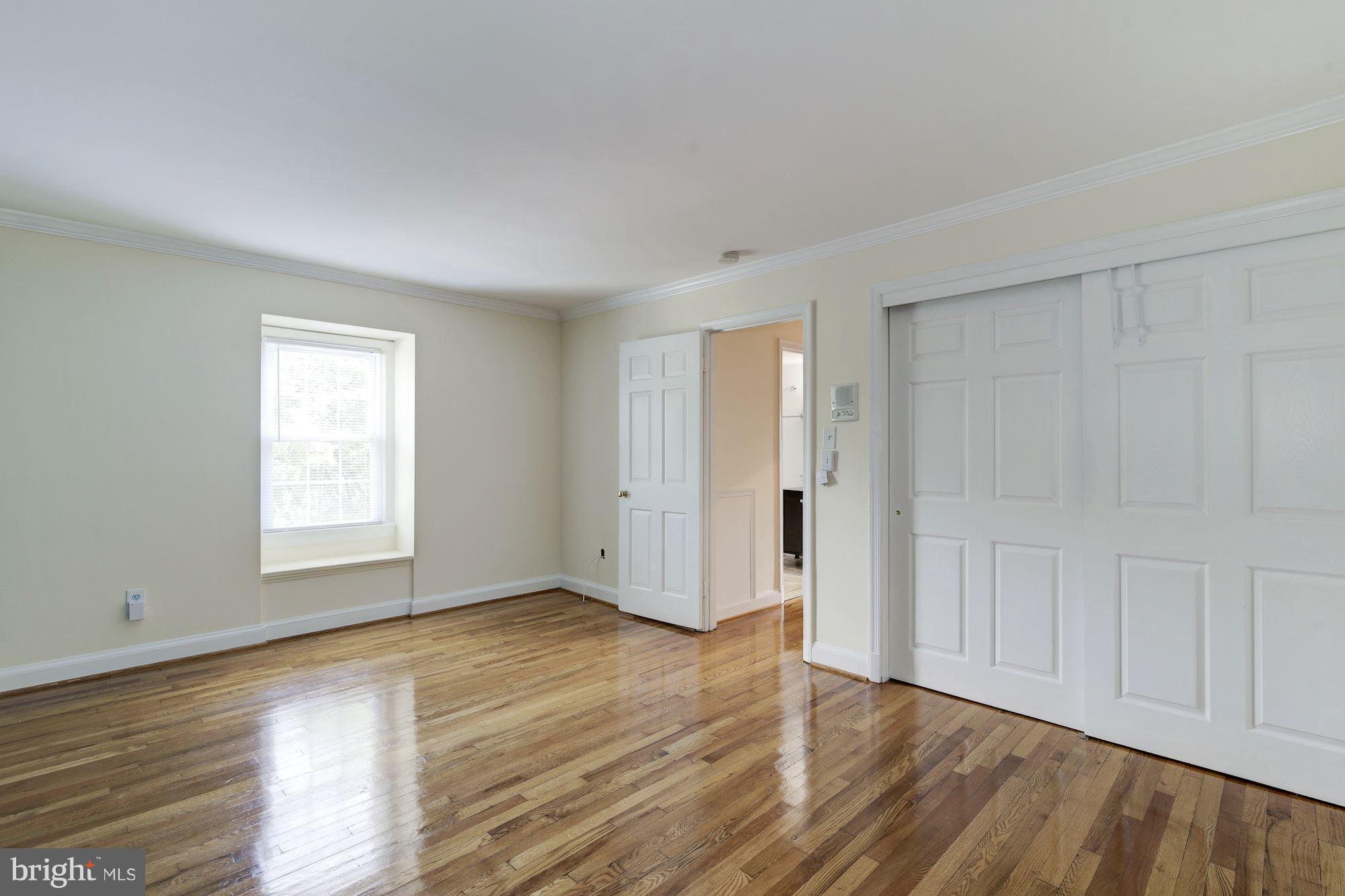 4200 River Road Northwest Washington, DC 20016 - Photo 16 of 30 a view of an empty room with wooden floor and a window