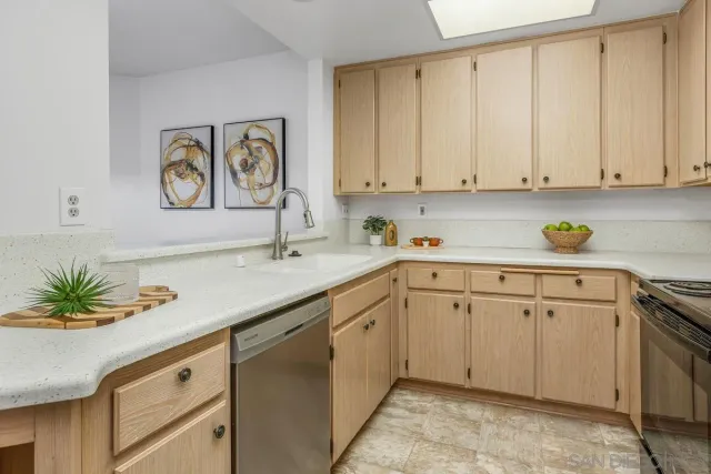 a kitchen with cabinets and window