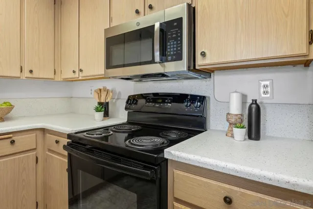 a kitchen with stainless steel appliances granite countertop a stove and a microwave