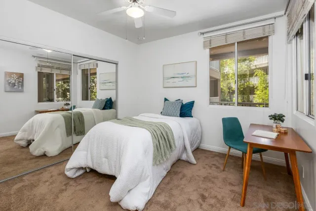 a bedroom with two beds and a window