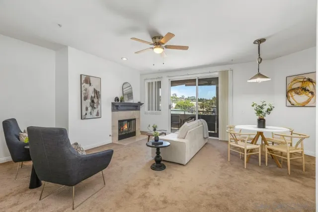a living room with furniture a fireplace and a chandelier