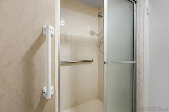 a bathroom with a glass shower door