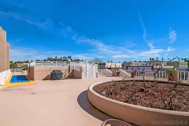 a view of a swimming pool with an outdoor seating and a garden