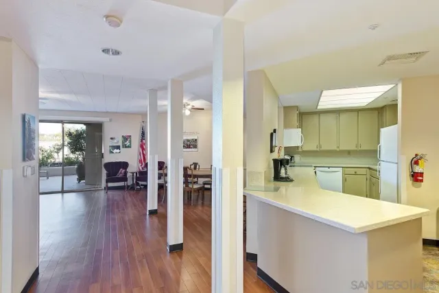 a kitchen with wooden floor and refrigerator