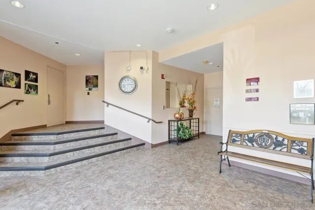 a spacious bedroom with a bed and a ceiling fan