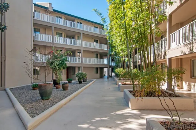 a front view of a building with potted plants