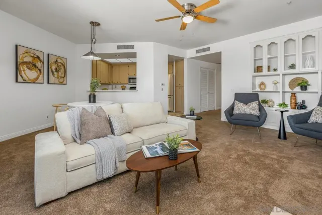 a living room with furniture and a chandelier