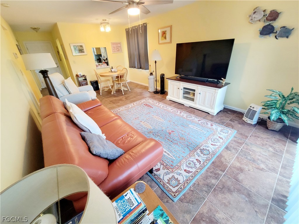 2206 East 6th Street Lehigh Acres, FL 33936 - Photo 15 of 30 a living room with furniture and a flat screen tv