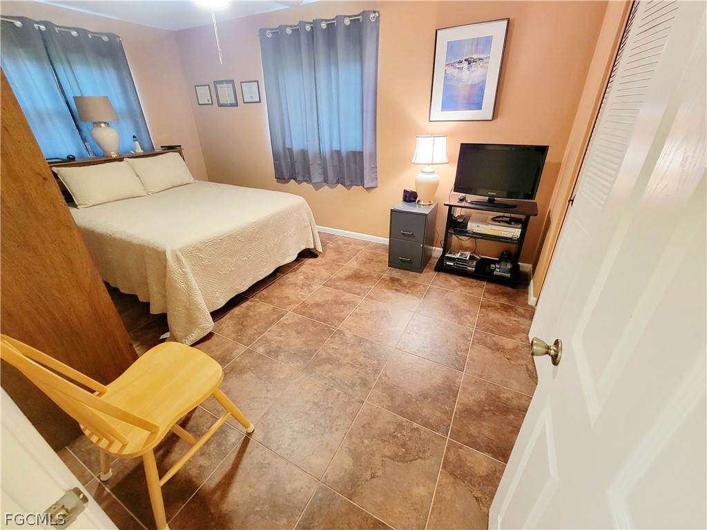 2206 East 6th Street Lehigh Acres, FL 33936 - Photo 18 of 30 a bedroom with a bed and furniture