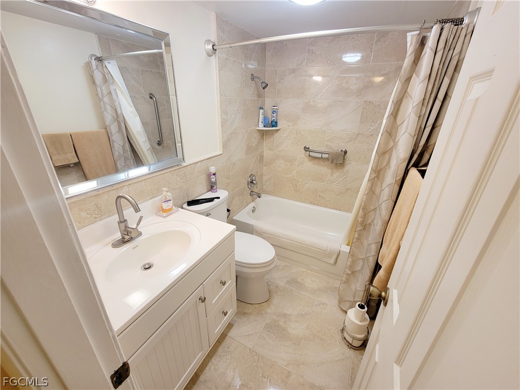 2206 East 6th Street Lehigh Acres, FL 33936 - Photo 20 of 30 a bathroom with a sink a toilet and shower a mirror