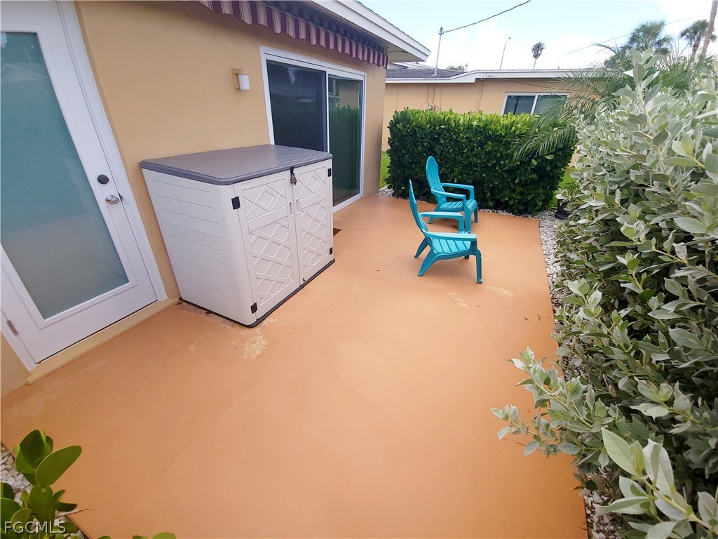 2206 East 6th Street Lehigh Acres, FL 33936 - Photo 26 of 30 a view of a patio with table and chairs and potted plants