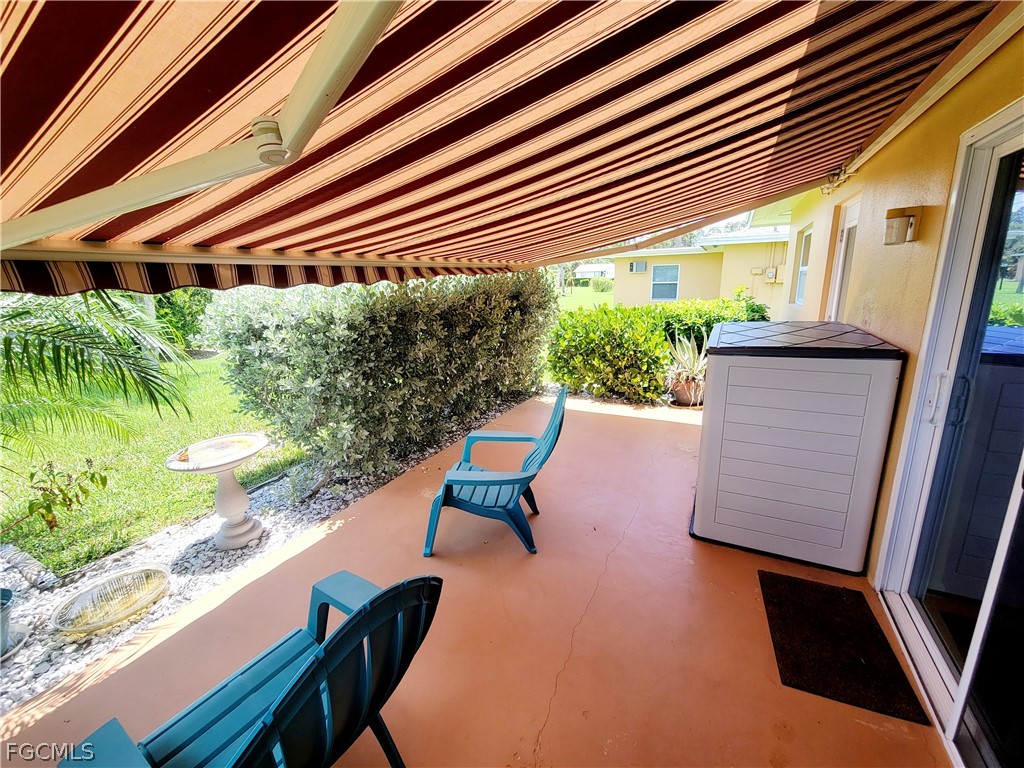 2206 East 6th Street Lehigh Acres, FL 33936 - Photo 28 of 30 a wooden bench sitting in front of a building