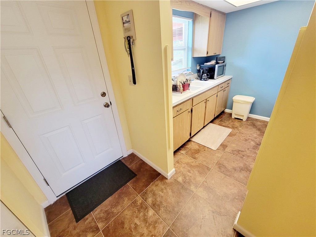 2206 East 6th Street Lehigh Acres, FL 33936 - Photo 9 of 30 a view of a hallway with washer and dryer