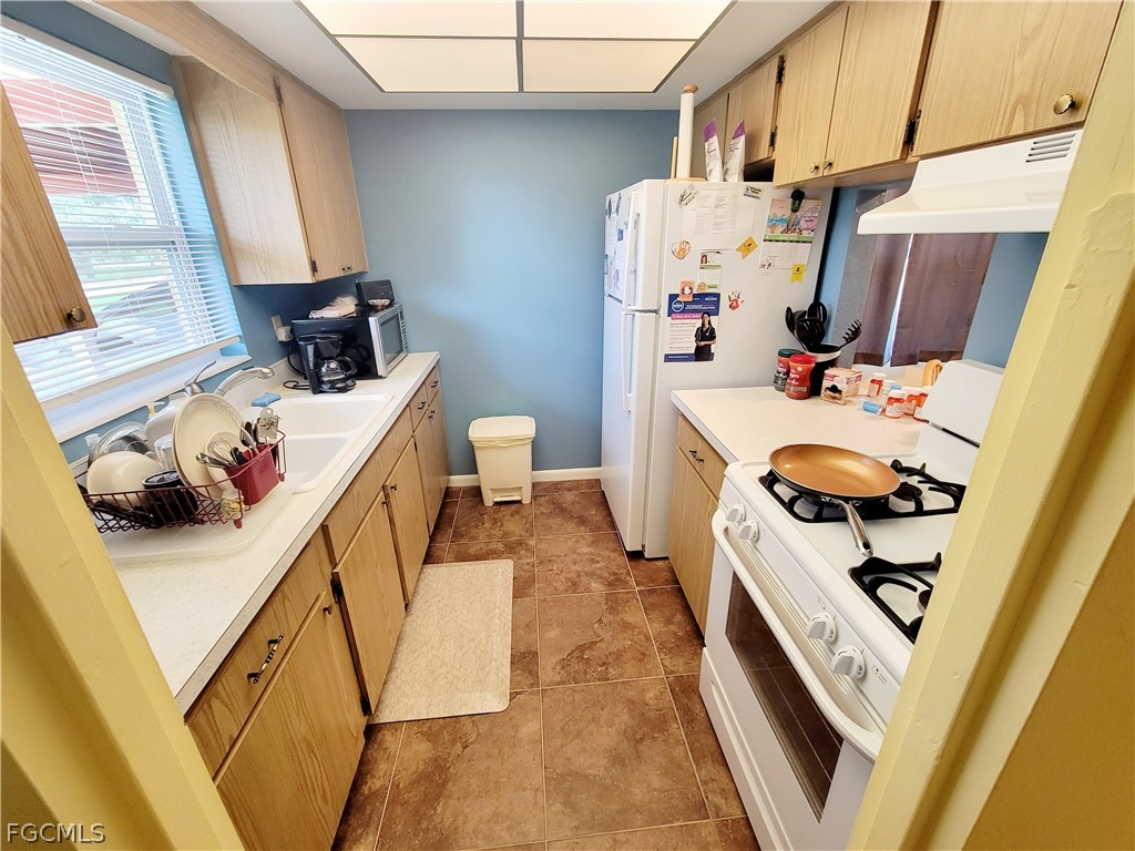 2206 East 6th Street Lehigh Acres, FL 33936 - Photo 10 of 30 a room with a sink a washer and dryer