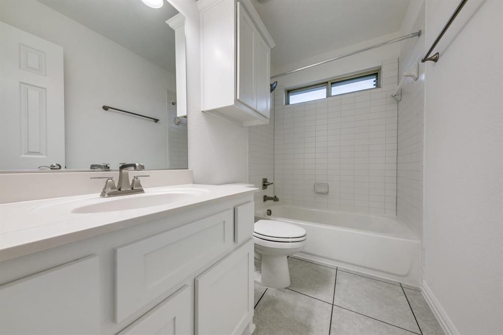 104 Sweetleaf Drive Red Oak, TX 75154 - Photo 23 of 36 Bathroom featuring a vanity with a white countertop and sink, a mirror, and white cabinetry