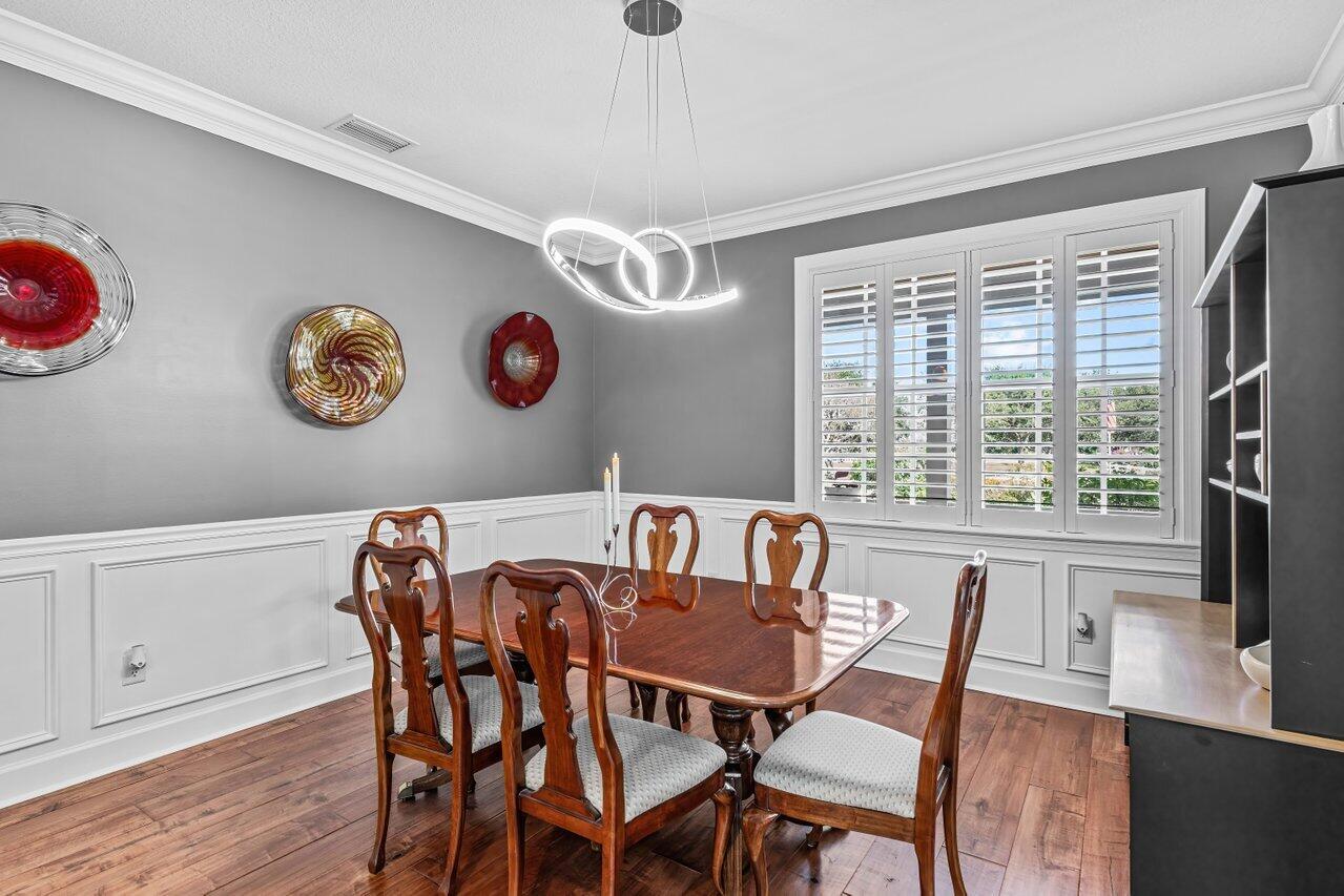 1802 Southwest Trailside Path Stuart, FL 34997 - Photo 11 of 57 a view of a dining room with furniture and wooden floor